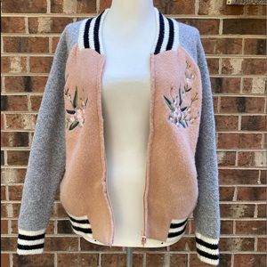 Sweater jacket with embroidered flowers.